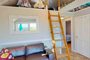 a living room with a couch and a ladder at Anchorage Escape in Truro