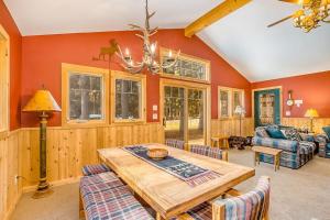 a dining room with a wooden table and chairs at Whispering Pines in Thompsonville