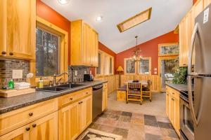 a kitchen with orange walls and wooden cabinets at Whispering Pines in Thompsonville
