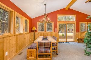 a dining room with a wooden table and chairs at Whispering Pines in Thompsonville +25 photos