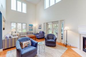 a living room with two chairs and a fireplace at Sea Colony - 56010 Pine Shore in Bethany Beach