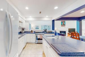 a large kitchen with white cabinets and blue walls at Sea Colony - 56010 Pine Shore in Bethany Beach +46 photos