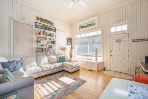 a living room with a white couch and a door at Lake Daze in Boyne City