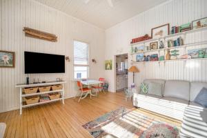 a living room with a couch and a flat screen tv at Lake Daze in Boyne City