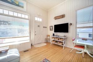 a living room with a flat screen tv and a desk at Lake Daze in Boyne City +38 photos