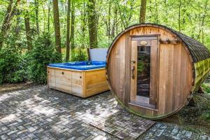 a large wooden tub sitting in the woods at Eagles Nest in New Buffalo