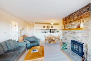 a living room with a couch and a fireplace at Gentle Winds 9 10 in Glen Arbor