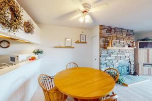 a dining room with a wooden table and chairs at Gentle Winds 9 10 in Glen Arbor
