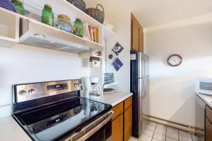 a kitchen with a stove and a refrigerator at Gentle Winds 9 10 in Glen Arbor