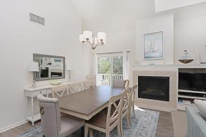 a dining room with a table and a fireplace at Sea Colony - 55021 Pine Lake in Bethany Beach