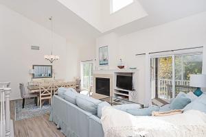 a living room with a couch and a fireplace at Sea Colony - 55021 Pine Lake in Bethany Beach