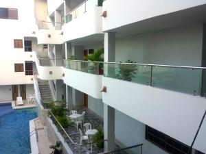 a view from the balcony of a building with a swimming pool at Hotel Dorado BAQ in Barranquilla