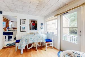 a dining room with a table and a window at Paradise by Ocean Edge in Brewster