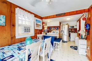 a kitchen and dining room with a table and chairs at Paradise by Ocean Edge in Brewster