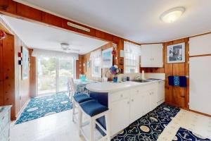a kitchen with a sink and a table with chairs at Paradise by Ocean Edge in Brewster