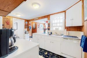 a kitchen with white cabinets and a sink at Paradise by Ocean Edge in Brewster +23 photos