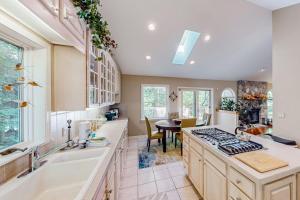 a kitchen with a sink and a stove at Betsie Woods in Thompsonville +39 photos