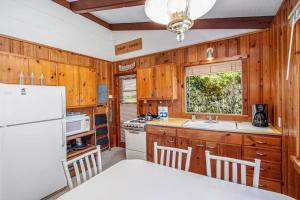 a kitchen with wooden cabinets and a white refrigerator at Camp David in Frankfort