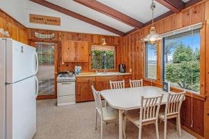 a kitchen with a table and a white refrigerator at Camp David in Frankfort