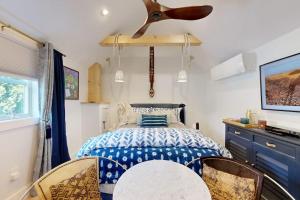 a bedroom with a bed and a ceiling fan at Sankofa Studio in Oak Bluffs
