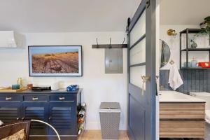 a kitchen with a blue door and a sink at Sankofa Studio in Oak Bluffs +4 photos