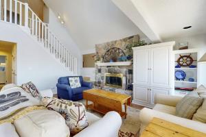 a living room with white furniture and a fireplace at Heron Creek in Laketown Township