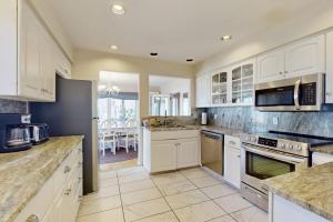 a large kitchen with white cabinets and appliances at Heron Creek in Laketown Township