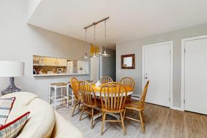 a dining room and kitchen with a table and chairs at Wilderness 9 in Glen Arbor