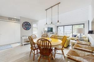 a dining room and living room with a table and chairs at Wilderness 9 in Glen Arbor