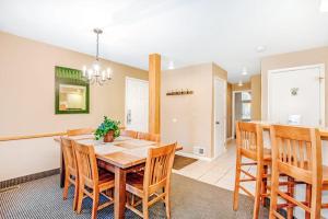 a kitchen and dining room with a table and chairs at Crystal Mountain Condo - Wintergreen 535 in Thompsonville