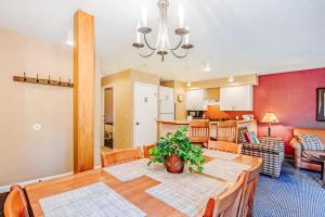 a dining room and living room with a dining table at Crystal Mountain Condo - Wintergreen 535 in Thompsonville
