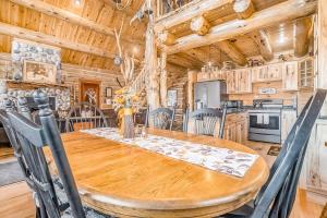 a dining room and kitchen with a wooden table and chairs at Salmon Run in Thompsonville