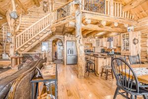 a log cabin kitchen with a wooden ceiling at Salmon Run in Thompsonville