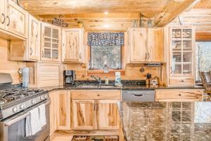 a kitchen with wooden cabinets and a stove at Salmon Run in Thompsonville