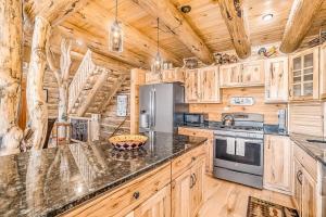 a kitchen with wooden cabinets and a stove top oven at Salmon Run in Thompsonville +35 photos