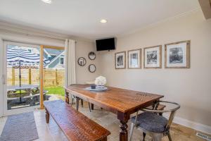 a dining room with a wooden table and chairs at Surf's Up in New Buffalo