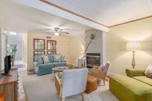 a living room with a couch and a table at Painted Porch Cottage in Lakeside