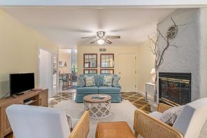 a living room with a blue couch and a fireplace at Painted Porch Cottage in Lakeside
