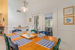 a dining room table with blue and white checkered napkins on it at Painted Porch Cottage in Lakeside