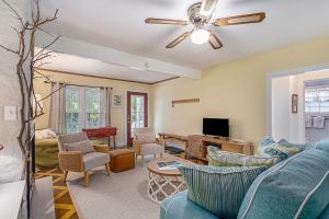 a living room with a blue couch and chairs at Painted Porch Cottage in Lakeside