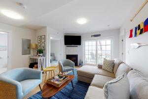 a living room with a couch and a table at Villa Balena - A Cape Cod Oasis in Dennis Port