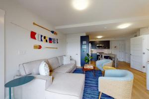 a living room with a white couch and chairs at Villa Balena - A Cape Cod Oasis in Dennis Port