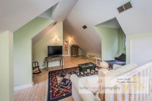 a living room with a couch and a tv at La Colita in Harbert +11 photos
