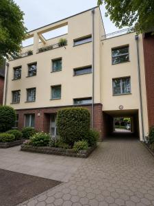 a large building with a driveway in front of it at Hotel Night4Flight Hamburg-Airport in Hamburg +14 photos