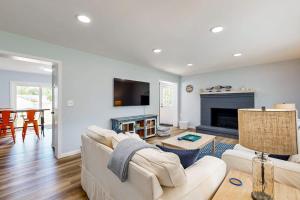 a living room with a white couch and a fireplace at Mill Run Estates --- 31863 Mill Run Dr in Ocean View