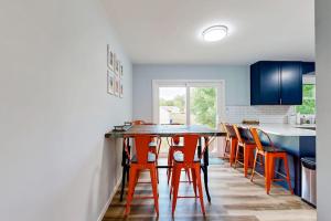 a kitchen with a table and some orange chairs at Mill Run Estates --- 31863 Mill Run Dr in Ocean View