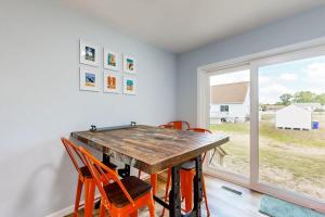 a dining room with a wooden table and orange chairs at Mill Run Estates --- 31863 Mill Run Dr in Ocean View