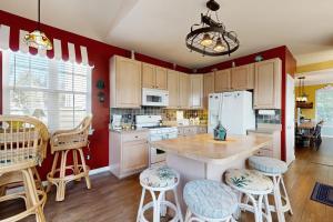 a kitchen with red walls and a white refrigerator at Wedgefield --- 23 Wedgefield in Ocean View +25 photos