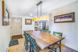 a kitchen and dining room with a wooden table and chairs at Red Pine Retreat in Thompsonville