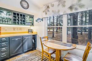 a kitchen with a table and a clock on the wall at Red Pine Retreat in Thompsonville